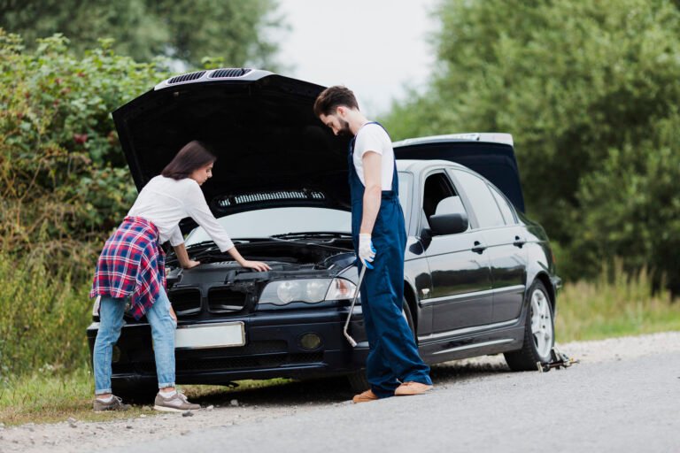 man woman checking car engine