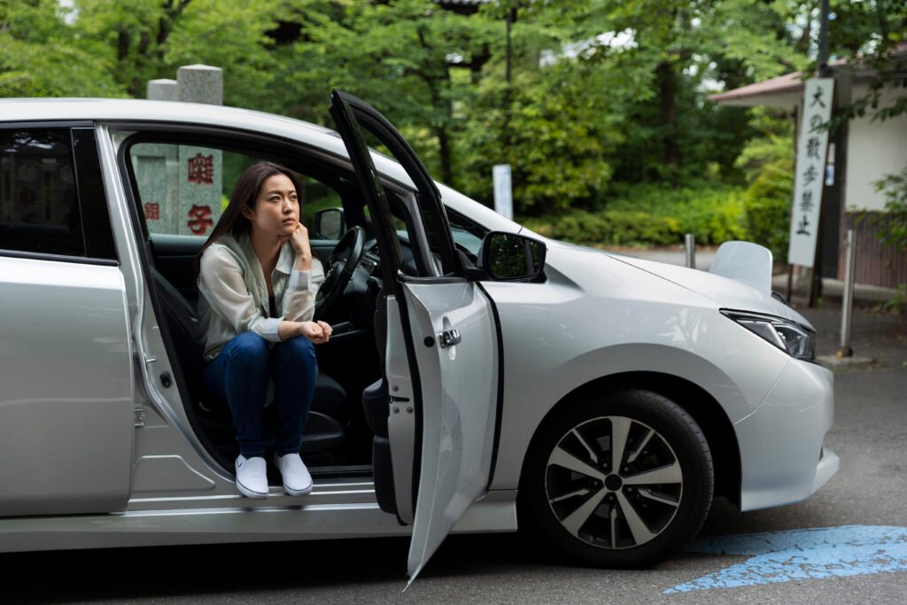 woman sitting her electric car
