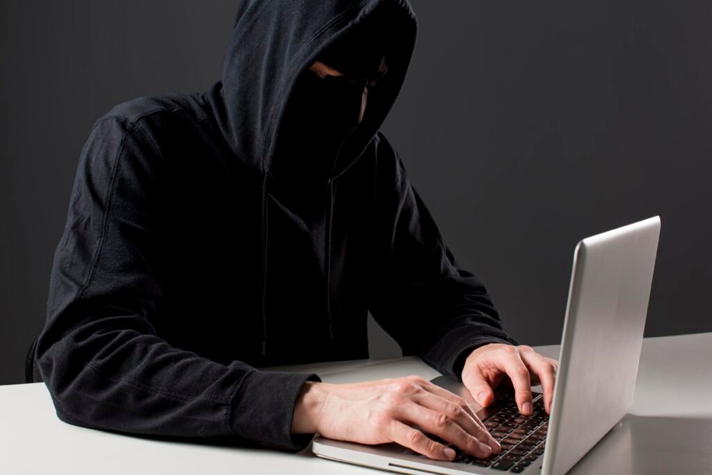 male hacker with laptop